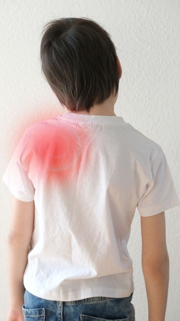 Child’s shoulder highlighted red, seen from behind, representing nerve injury recovery