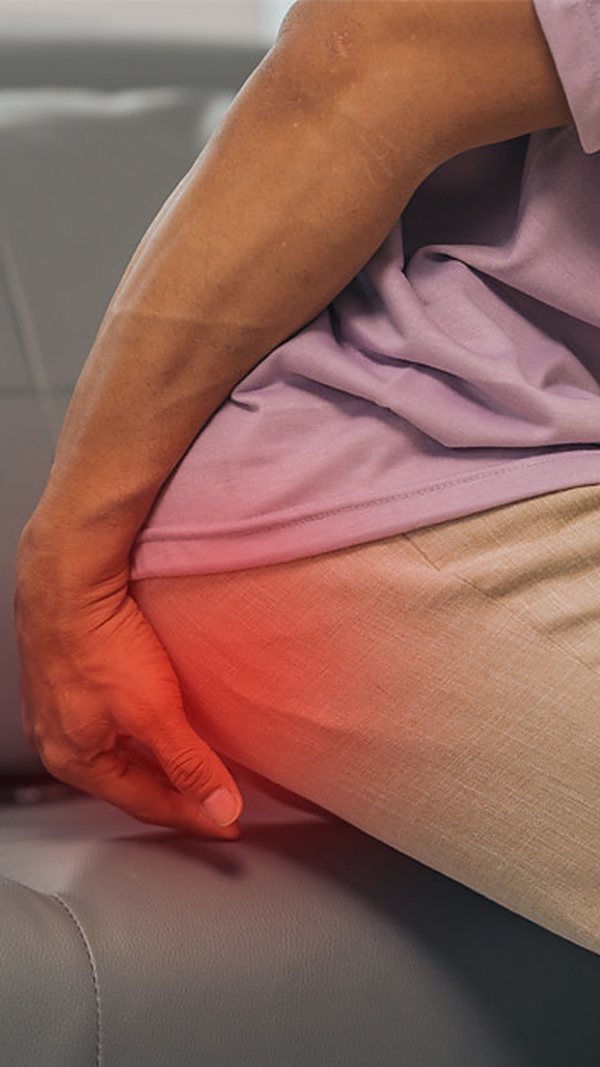 Man holding his buttock in pain, representing piriformis syndrome
