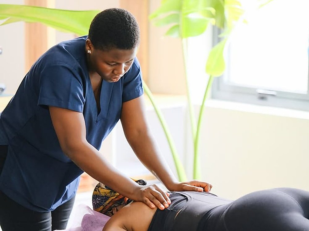 A physiotherapist treating a patient at home