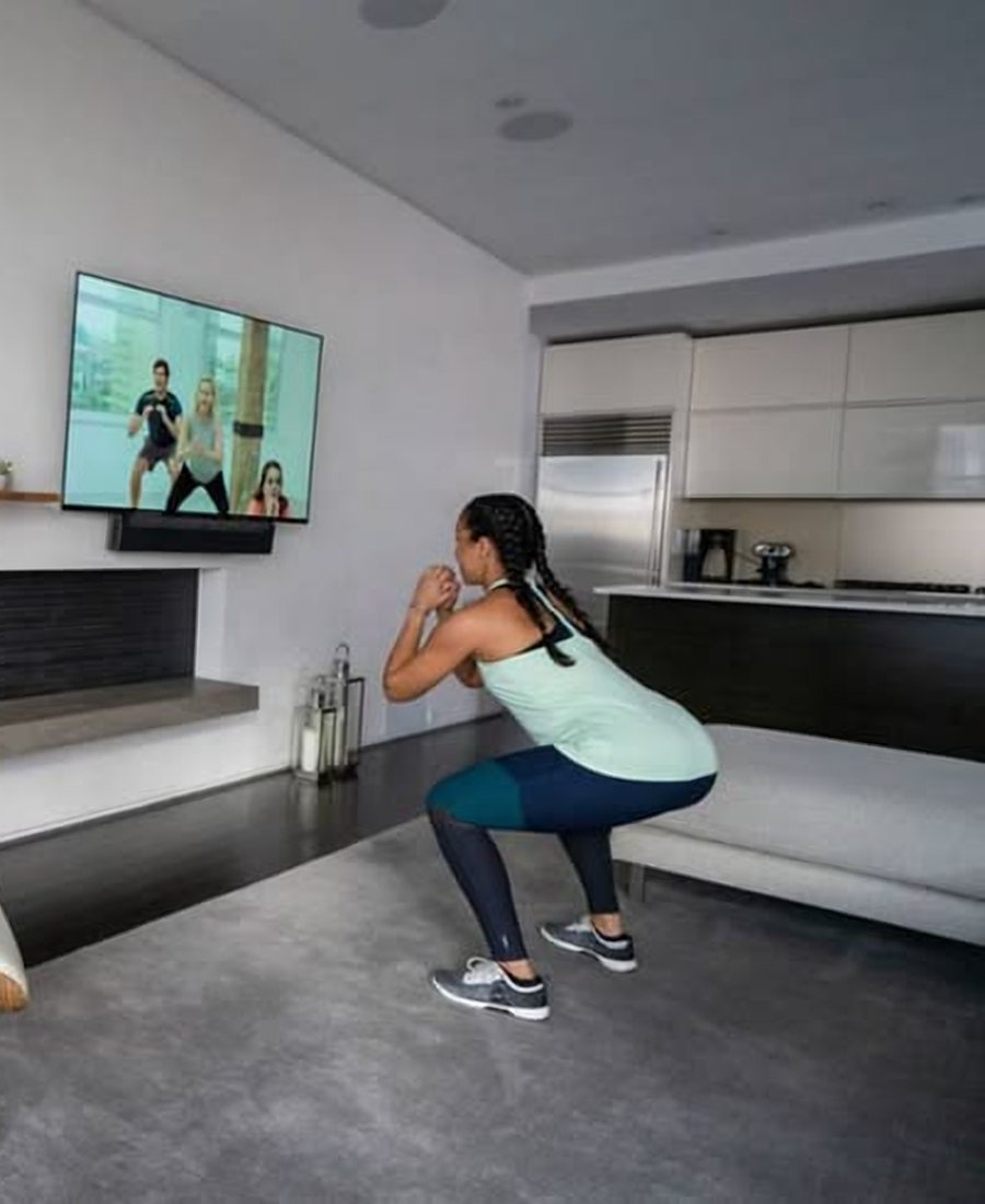 Woman following a guided exercise video at home